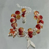 Armband mit Herbstblatt und Schmetterling in Weißgold