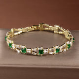 Tennisarmband mit grünen Gliedern in Gold